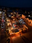 Realistic nighttime Christmas market scene in Cyprus with wooden stalls and warm lights.